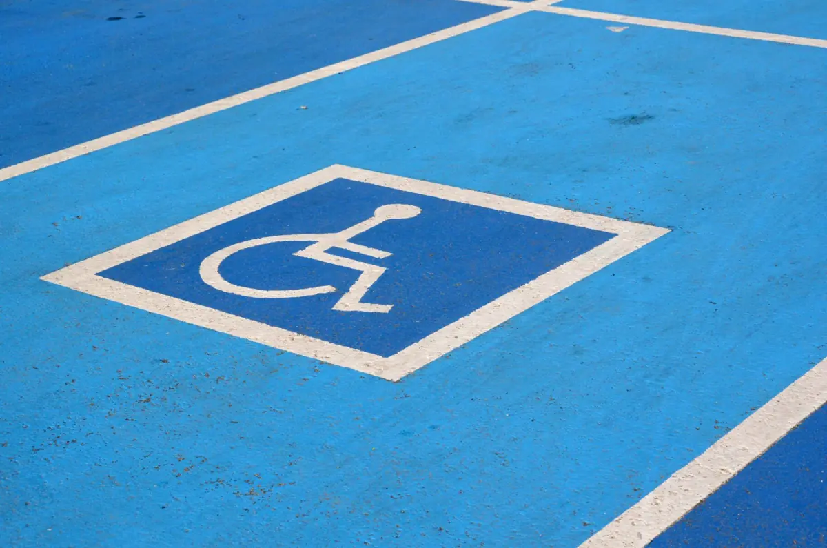 Blue accessible parking space with a white wheelchair symbol